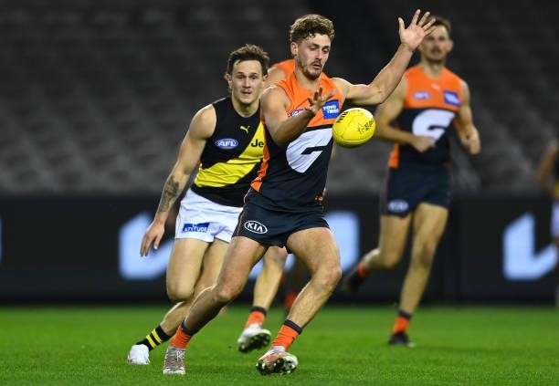 Harry Perryman of the Giants kicks during the round 22 AFL match between Greater Western Sydney Giants and Richmond Tigers at Marvel Stadium on...