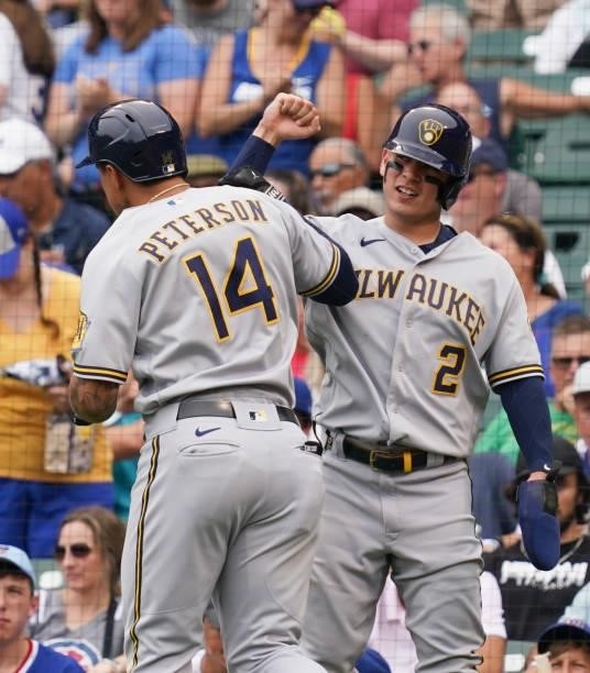 Jace Peterson of the Milwaukee Brewers is congratulated by Luis Urias following his two-run home run against the Chicago Cubs at Wrigley Field on...