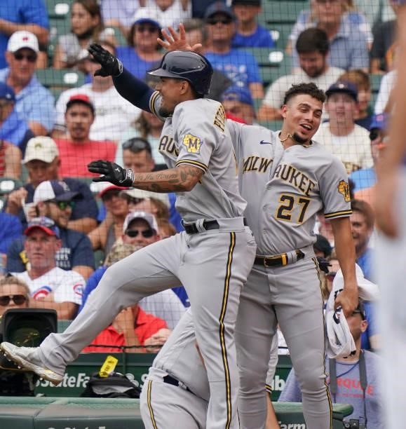 Jace Peterson of the Milwaukee Brewers is congratulated by Willy Adames following his two-run home run against the Chicago Cubs at Wrigley Field on...
