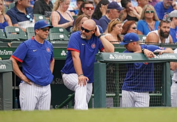 Manager David Ross of the Chicago Cubs stands in the dugout during a game against the Milwaukee Brewers at Wrigley Field on August 12, 2021 in...