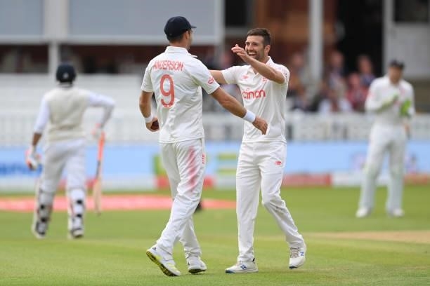 Jimmy Anderson of England celebrates with Mark Wood after combining to dismiss Ravindra Jadeja of India during the Second LV= Insurance Test Match:...