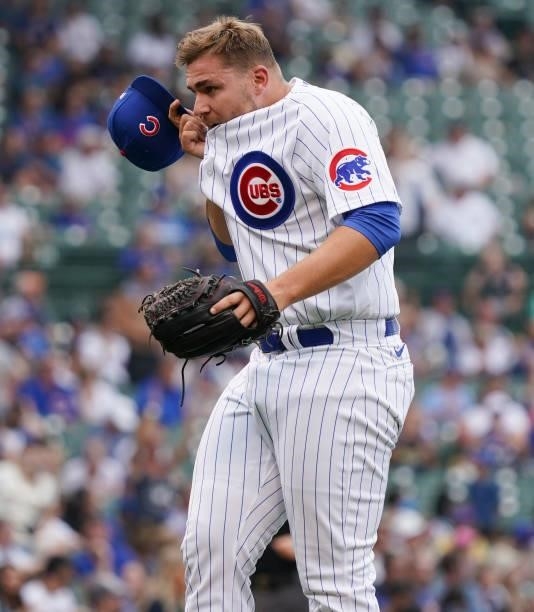 Ryan Meisinger of the Chicago Cubs wipes his face after giving up a two-run home run to Manny Pina of the Milwaukee Brewers during the sixth inning...