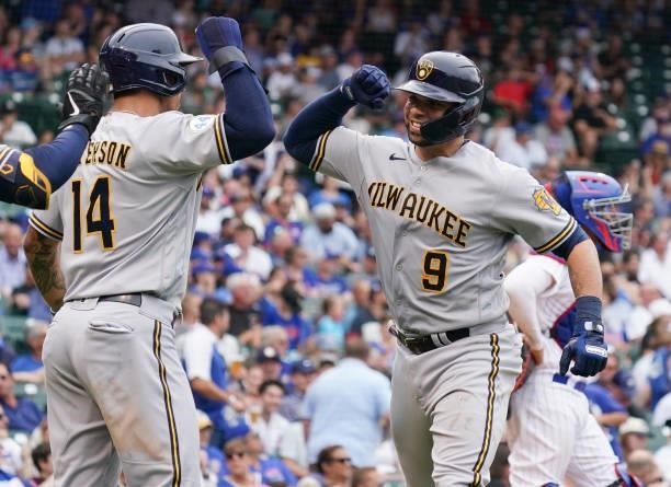 Manny Pina of the Milwaukee Brewers is congratulated by Jace Peterson following his two-run home run during the sixth inning of a game against the...