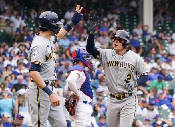 Luis Urias of the Milwaukee Brewers is congratulated by Christian Yelich following his two-run home run during the seventh inning of a game against...