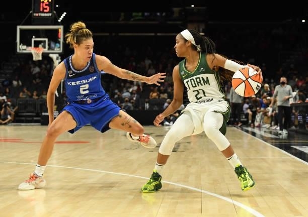 Jordin Canada of the Seattle Storm dribbles the ball while being defended by Natisha Hiedeman of the Connecticut Sun during the first half of the...