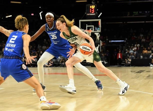 Breanna Stewart of the Seattle Storm drives to the basket while being defended by Natisha Hiedeman and Jonquel Jones of the Connecticut Sun during...