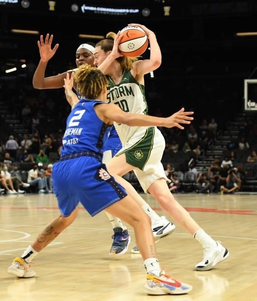 Breanna Stewart of the Seattle Storm drives to the basket while being defended by Natisha Hiedeman and Jonquel Jones of the Connecticut Sun during...