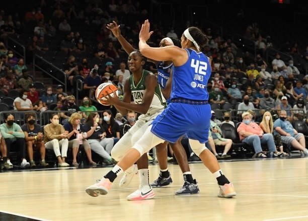 Ezi Magbefor of the Seattle Storm attempts to pass the ball while being defended by Brionna Jones and Beatrice Mompremier of the Connecticut Sun...