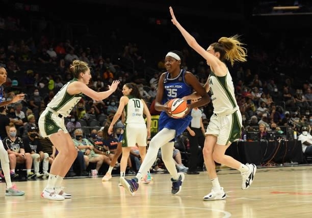 Jonquel Jones of the Connecticut Sun drives to the basket while being defended by Katie Lou Samuelson and Breanna Stewart of the Seattle Storm during...
