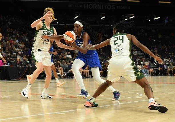 Jonquel Jones of the Connecticut Sun drives to the basket while being defended by Breanna Stewart and Jewell Loyd of the Seattle Storm during the...