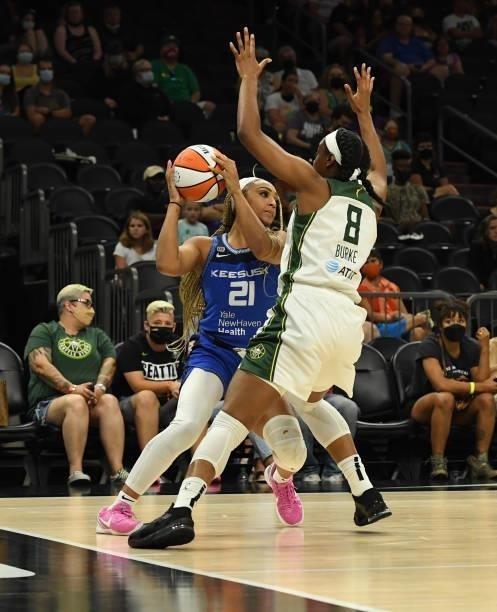 DiJonai Carrington of the Connecticut Sun looks to pass the ball while being defended by Kennedy Burke of the Seattle Storm during the 2021...