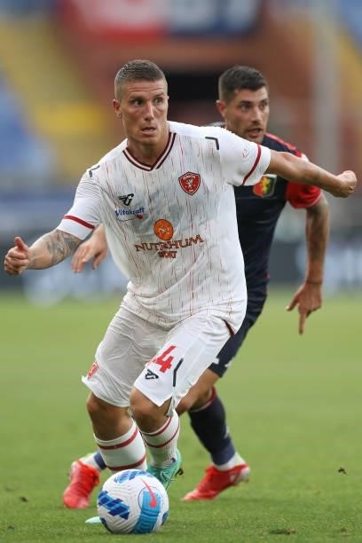 Francesco Lisi of AC Perugia Calcio runs with the ball under pressure of Stefano Sabelli of Genoa CFC during the Coppa Italia match between Genoa CFC...