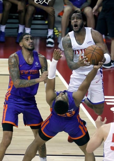 Walker of the New York Knicks takes a charge from Saddiq Bey of the Detroit Pistons as Obi Toppin of the Knicks defends during the 2021 NBA Summer...