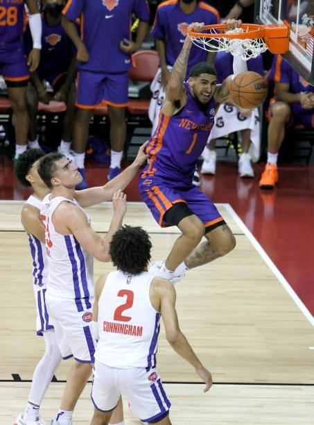Obi Toppin of the New York Knicks dunks against Luka Garza and Cade Cunningham of the Detroit Pistons during the 2021 NBA Summer League at the Thomas...