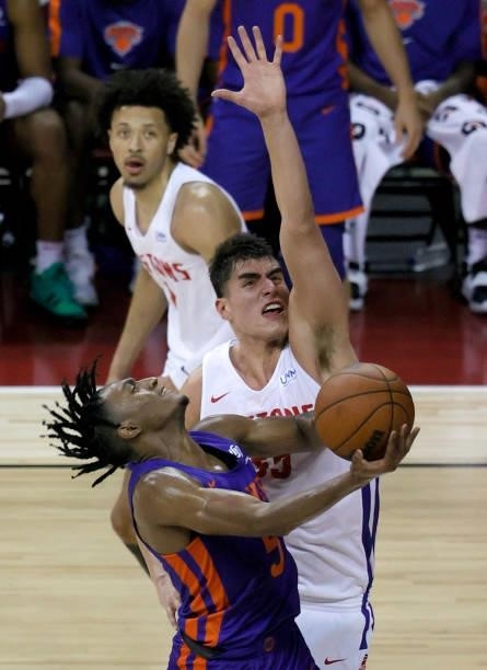 Immanuel Quickley of the New York Knicks drives to the basket against Luka Garza of the Detroit Pistons during the 2021 NBA Summer League at the...