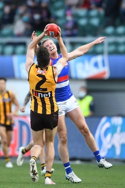 Mitch Lewis of the Hawks and Laitham Vandermeer of the Bulldogs compete for the ball during the round 22 AFL match between Hawthorn Hawks and Western...