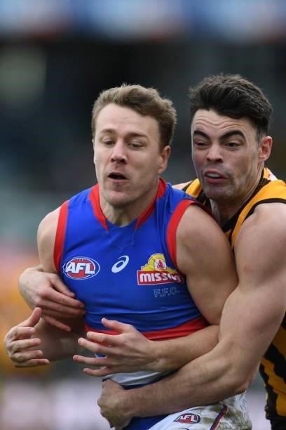 Lachie Hunter of the Bulldogs is tackled by Conor Nash of the Hawks during the round 22 AFL match between Hawthorn Hawks and Western Bulldogs at...