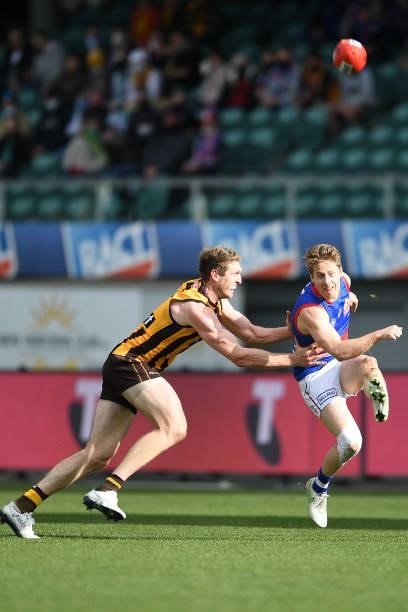 Lachie Hunter of the Bulldogs is tackled by Ben McEvoy of the Hawks during the round 22 AFL match between Hawthorn Hawks and Western Bulldogs at...