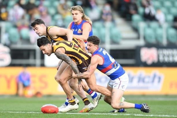 Chad Wingard of the Hawks is tackled by Tom Liberatore of the Bulldogs during the round 22 AFL match between Hawthorn Hawks and Western Bulldogs at...