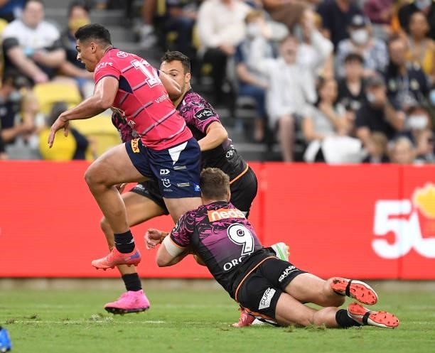 Heilum Luki of the Cowboys is tackled by Jacob Liddle of the Tigers during the round 22 NRL match between the North Queensland Cowboys and the Wests...