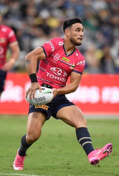 Valentine Holmes of the Cowboys passes the ball during the round 22 NRL match between the North Queensland Cowboys and the Wests Tigers at QCB...