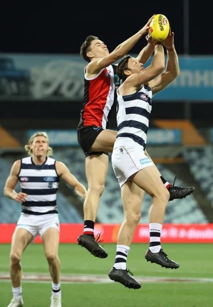 Lachie Henderson of the Cats is challenged by Cooper Sharman of the Saints during the round 22 AFL match between Geelong Cats and St Kilda Saints at...