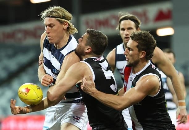 Mark Blicavs of the Cats is challenged by Brad Crouch of the Saints during the round 22 AFL match between Geelong Cats and St Kilda Saints at GMHBA...