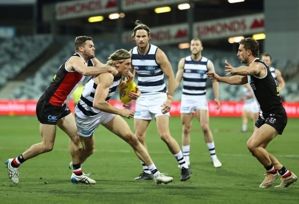 Mark Blicavs of the Cats is challenged by Brad Crouch of the Saints during the round 22 AFL match between Geelong Cats and St Kilda Saints at GMHBA...