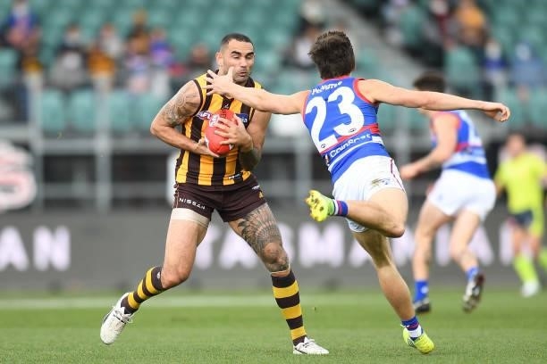 Shaun Burgoyne of the Hawks evades a tackle by Laitham Vandermeer of the Bulldogs during the round 22 AFL match between Hawthorn Hawks and Western...