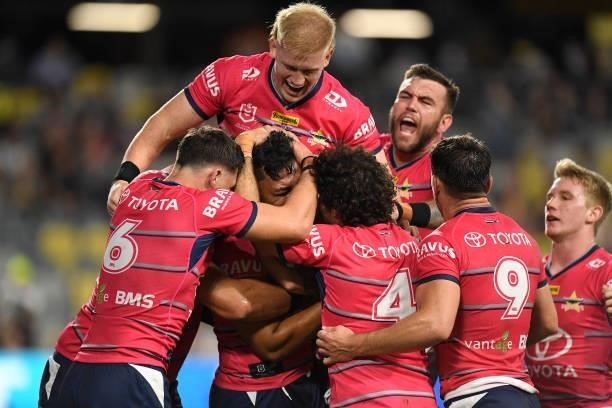 Jeremiah Nanai of the Cowboys celebrates with teammates after scoring a try during the round 22 NRL match between the North Queensland Cowboys and...