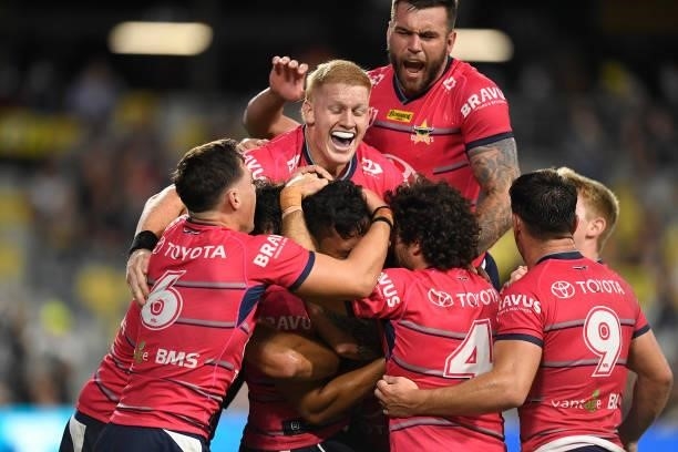 Jeremiah Nanai of the Cowboys celebrates with teammates after scoring a try during the round 22 NRL match between the North Queensland Cowboys and...