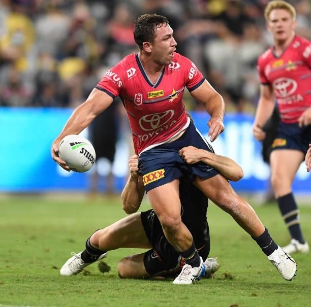 Reece Robson of the Cowboys looks to pass the ball during the round 22 NRL match between the North Queensland Cowboys and the Wests Tigers at QCB...