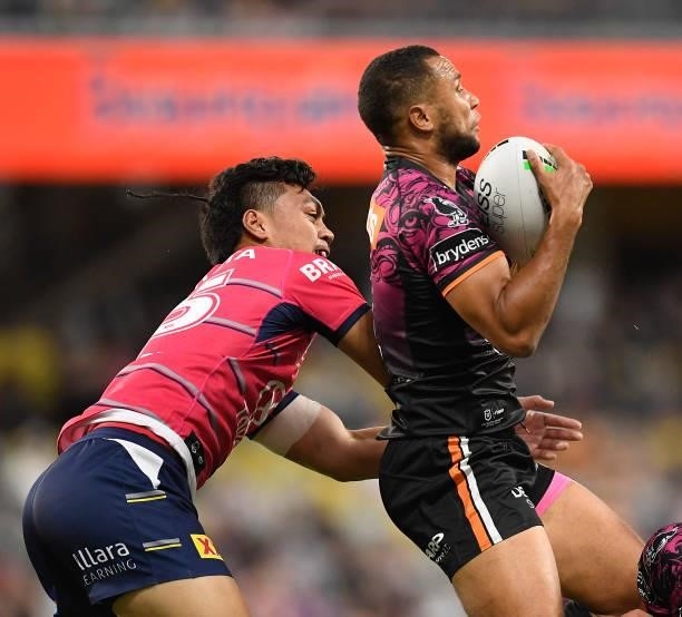 Moses Mbye of the Tigers takes a high ball in front of Jeremiah Nanai of the Cowboys during the round 22 NRL match between the North Queensland...