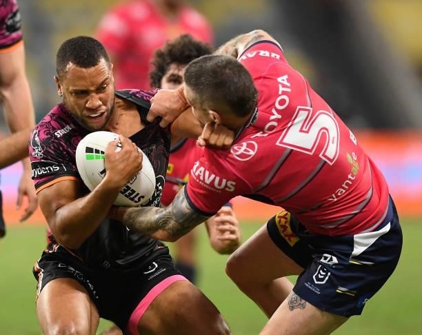 Moses Mbye of the Tigers is tackled by Ben Hampton of the Cowboys during the round 22 NRL match between the North Queensland Cowboys and the Wests...