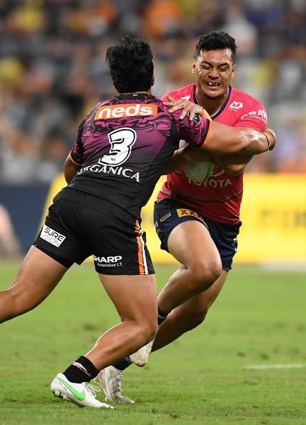 Jeremiah Nanai of the Cowboys is tackled by Tommy Talau of the Tigers during the round 22 NRL match between the North Queensland Cowboys and the...