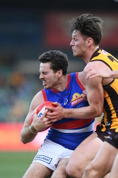 Zaine Cordy of the Bulldogs is tackled by Jacob Koschitzke of the Hawks during the round 22 AFL match between Hawthorn Hawks and Western Bulldogs at...