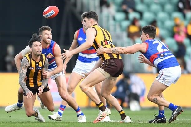 Chad Wingard of the Hawks is tackled by Marcus Bontempelli of the Bulldogs during the round 22 AFL match between Hawthorn Hawks and Western Bulldogs...