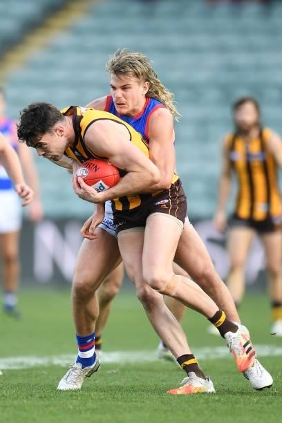 Conor Nash of the Hawks is tackled by Bailey Smith of the Bulldogs during the round 22 AFL match between Hawthorn Hawks and Western Bulldogs at...