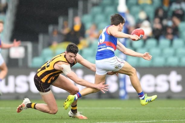Mitch Hannan of the Bulldogs is tackled by Conor Nash of the Hawks during the round 22 AFL match between Hawthorn Hawks and Western Bulldogs at...
