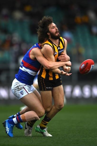 Tom Phillips of the Hawks is tackled during the round 22 AFL match between Hawthorn Hawks and Western Bulldogs at University of Tasmania Stadium on...