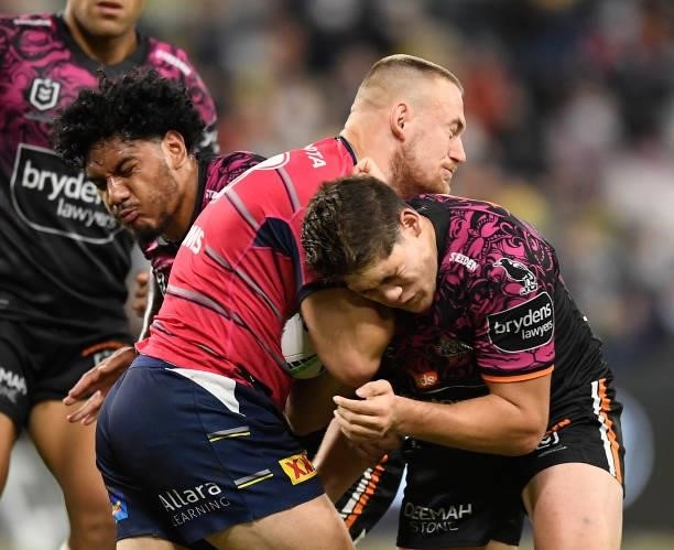 Coen Hess of the Cowboys is tackled during the round 22 NRL match between the North Queensland Cowboys and the Wests Tigers at QCB Stadium, on August...