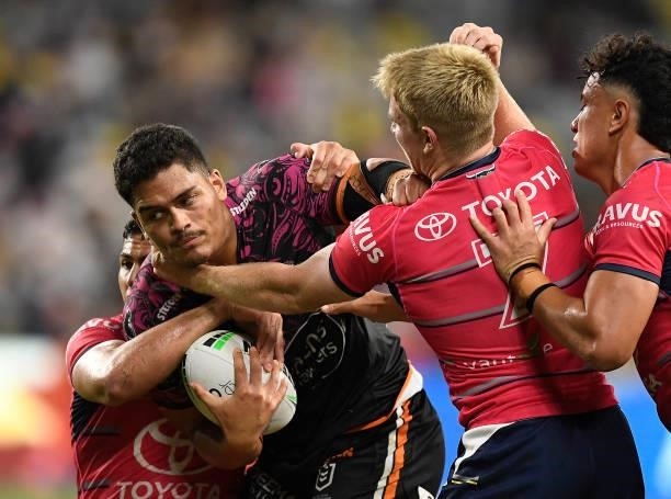 Shawn Blore of the Tigers is tackled during the round 22 NRL match between the North Queensland Cowboys and the Wests Tigers at QCB Stadium, on...