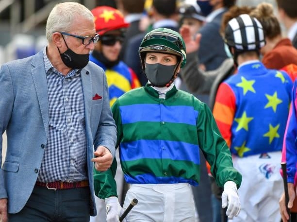 Jamie Kah wearing face mask is seen with trainer Mick Price before Race 4, the Mark Mazzaglia Handicap, during Melbourne Racing at Caulfield...