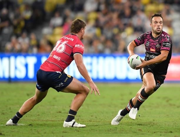 Luke Brooks of the Tigers runs the ball during the round 22 NRL match between the North Queensland Cowboys and the Wests Tigers at QCB Stadium, on...