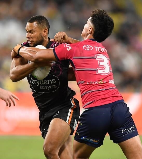 Moses Mbye of the Tigers is tackled by Daejarn Asi of the Cowboys during the round 22 NRL match between the North Queensland Cowboys and the Wests...