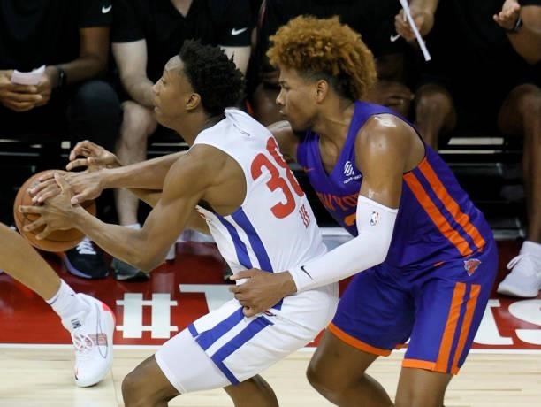 Miles McBride of the New York Knicks tries to steal the ball from Saben Lee of the Detroit Pistons during the 2021 NBA Summer League at the Thomas &...