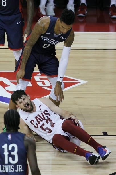 Didi Louzada of the New Orleans Pelicans looks at Chandler Vaudrin of the Cleveland Cavaliers after he suffered an injury in their game during the...