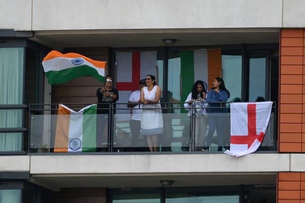 Fans watch from a nearby apartment during the Second LV= Insurance Test Match: Day Three between England and India at Lord's Cricket Ground on August...
