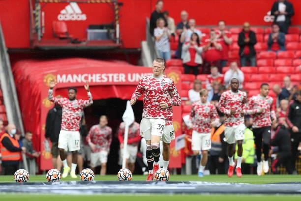Scott McTominay of Manchester United runs out for the warm up prior to the Premier League match between Manchester United and Leeds United at Old...