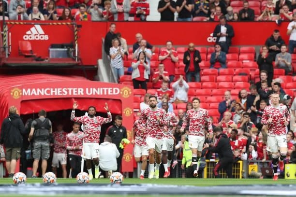 Bruno Fernandes of Manchester United runs out for the warm up prior to the Premier League match between Manchester United and Leeds United at Old...